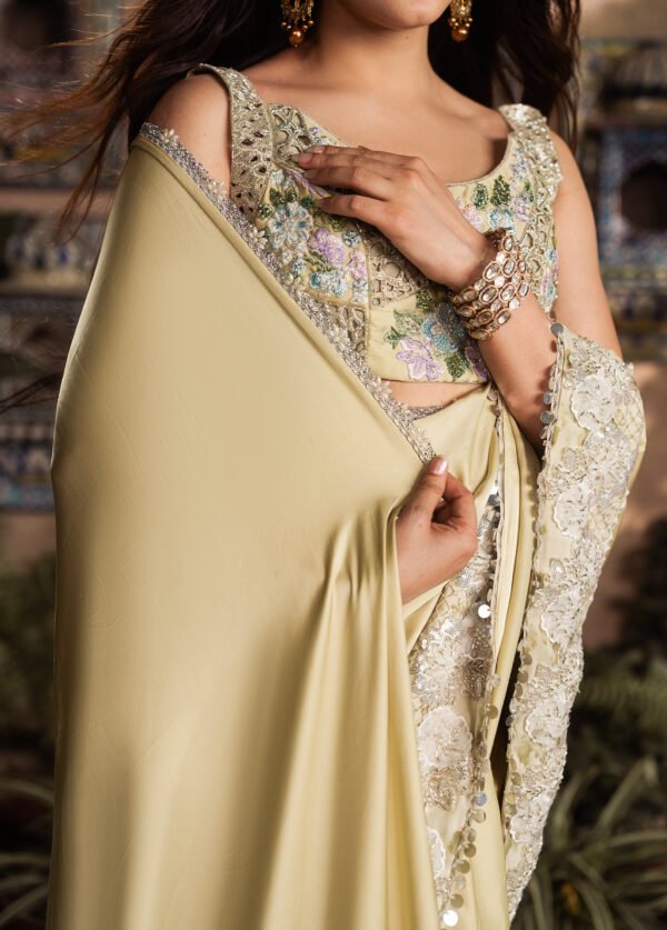 Close-up of Marigold embroidered blouse featuring floral embroidery, sequins, bugle beads and cut dana work.