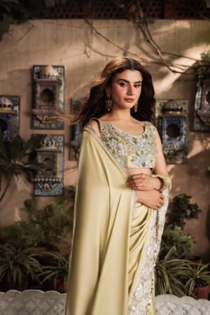 Model wearing Marigold luxury pure Shamooz silk saree with embroidered blouse and handcrafted embellishments.
