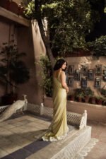Back view of Marigold luxury Shamooz silk saree showcasing graceful drape and embellished border.
